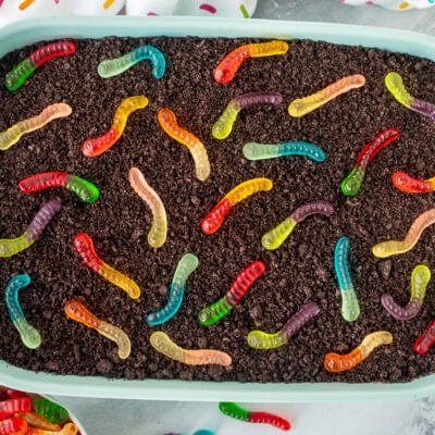 Mini gummy worms on top of Dirt Cake in a casserole dish.