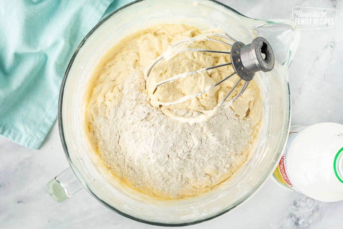 Alternating flour mixture and buttermilk into Easter cupcake batter.
