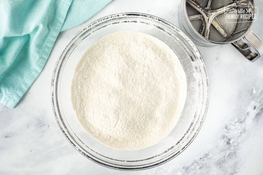 Sifted dry ingredients in a glass mixing bowl.