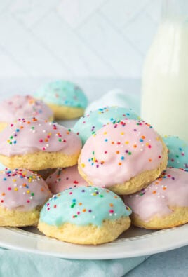Plate of Italian Easter cookies frosted with pink, purple and blue icing and sprinkles.