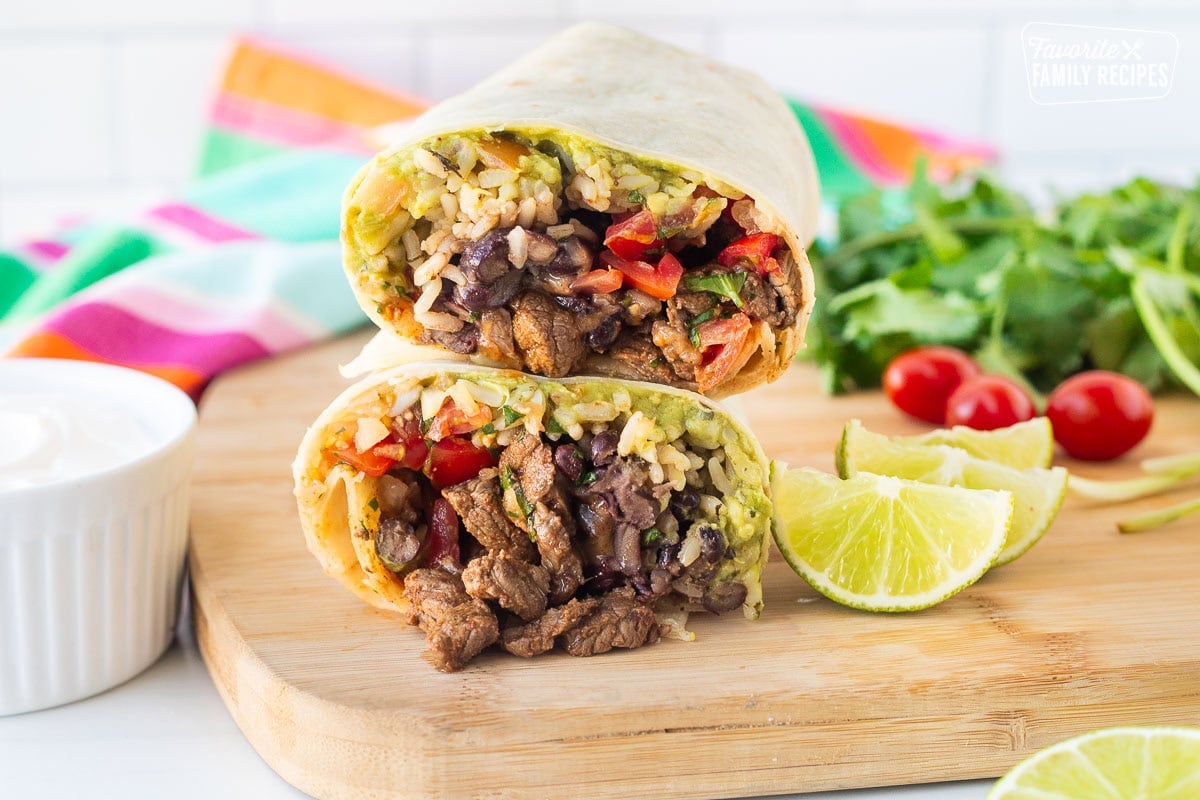 Carne Asada burrito filled with guacamole, pico de gallo, cilantro lime rice, black beans, shredded cheese and cut Carne Asada.