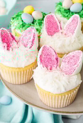 Easter cupcakes with marshmallow bunny ears and green coconut Cadbury egg bird nests.