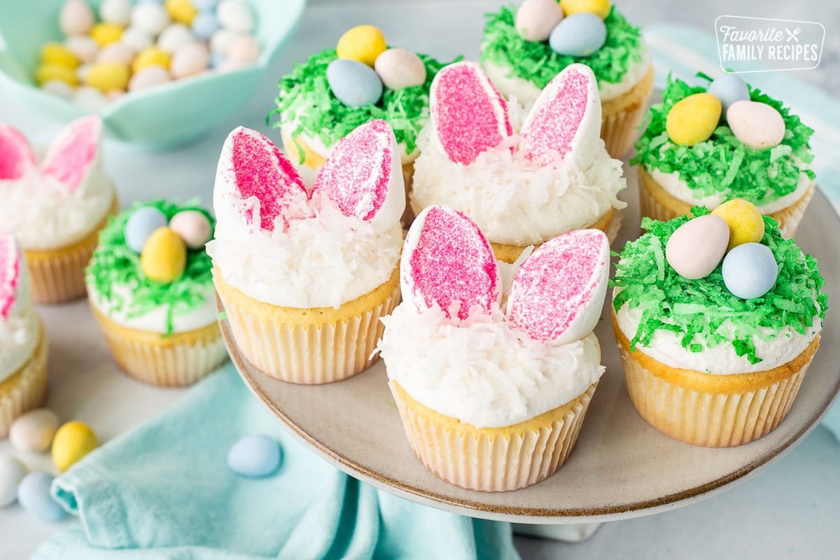 Easter cupcakes with marshmallow bunny ears and green coconut Cadbury egg bird nests.