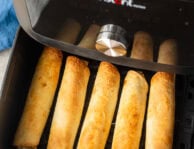 Golden chicken flautas in an air fryer.