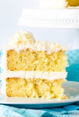 Slice of Coconut cream cake with coconut frosting.