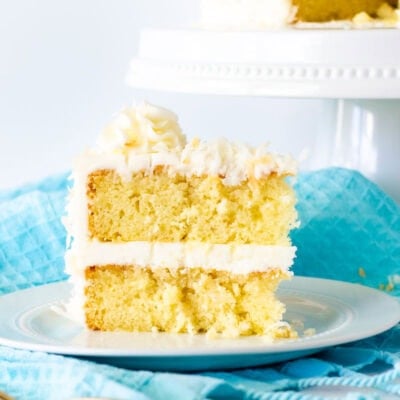 Slice of Coconut cream cake with coconut frosting.