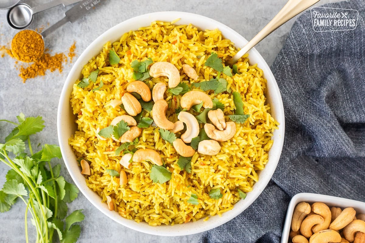 Coconut rice bowl with fresh cilantro and cashews on top.