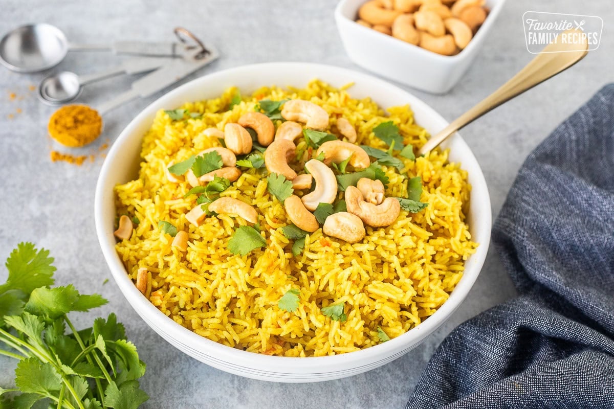 Bowl of coconut rice with cashews and cilantro.
