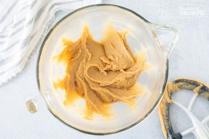 Glass mixing bowl with creamed sugar and butter. Paddle attachment on the side.
