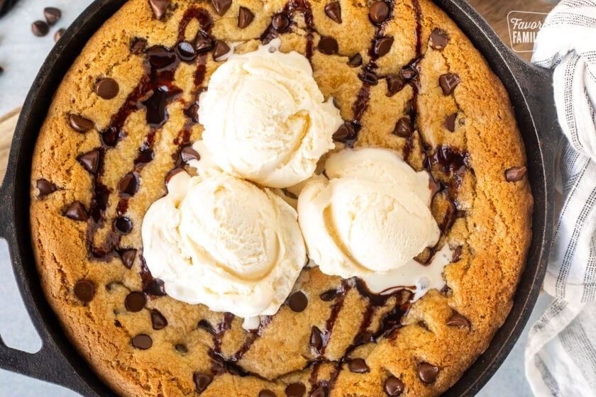 Pizookie in a skillet with three scoops of ice cream.