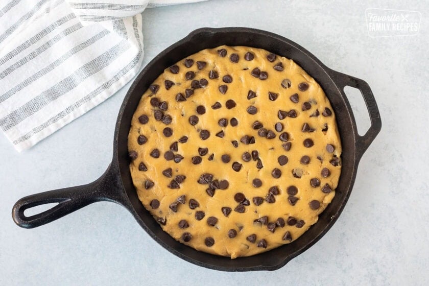 Chocolate chip cookie dough in a skillet.