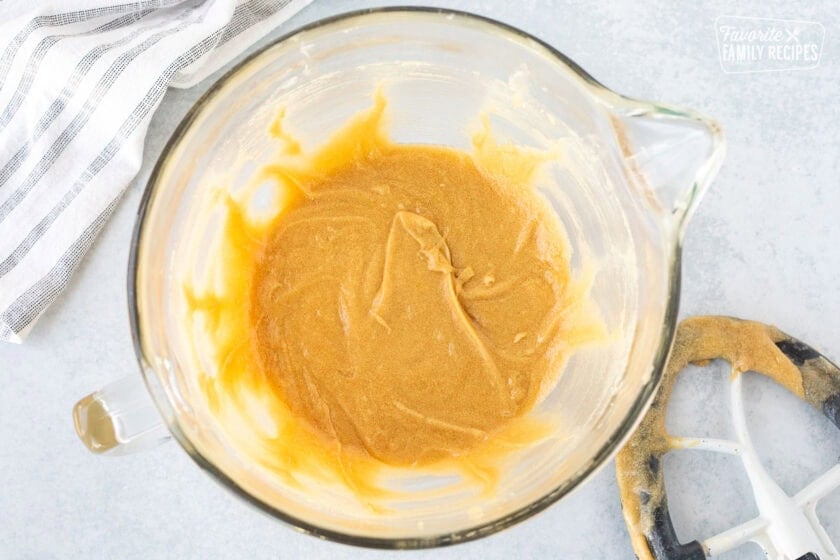 Glass mixing bowl with mixed creamed sugar, butter and egg.
