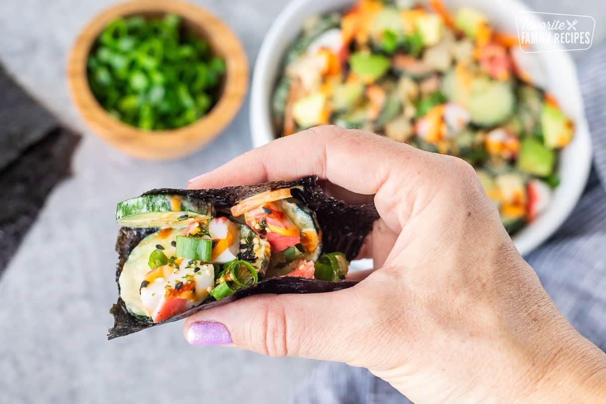 Nori with California Roll Cucumber Salad with sliced cucumbers, cut imitation crab, avocados, carrot, green onion, spicy mayo and sriracha.