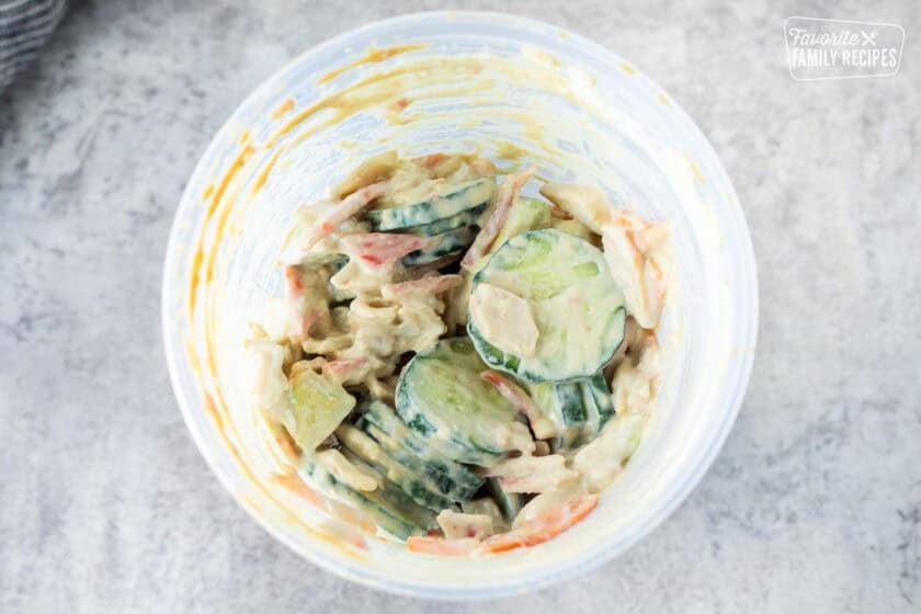 California Roll Cucumber Salad shake in a plastic container.
