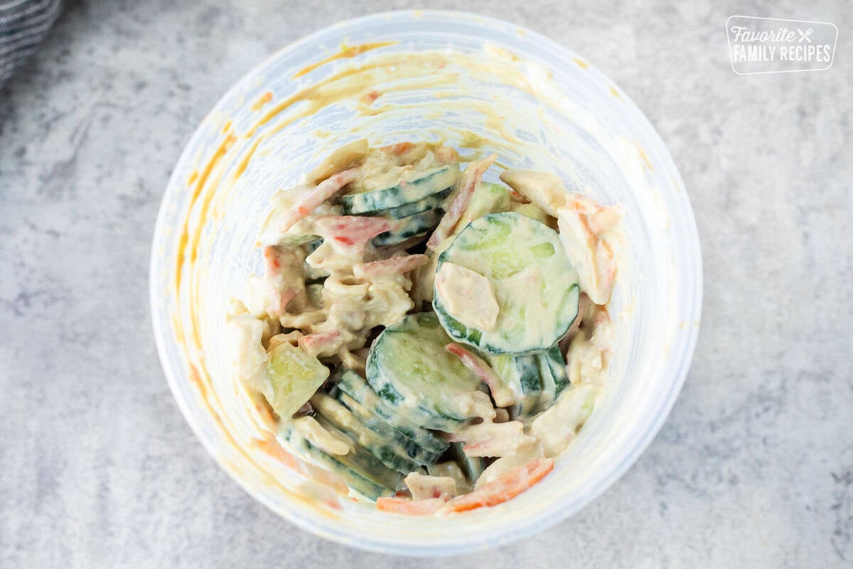 California Roll Cucumber Salad shake in a plastic container.