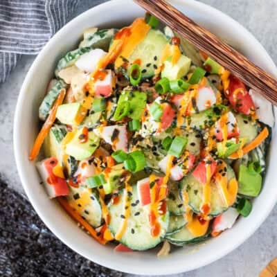 California Roll Cucumber Salad with sliced cucumbers, cut imitation crab, avocados, carrot, green onion, spicy mayo and sriracha.