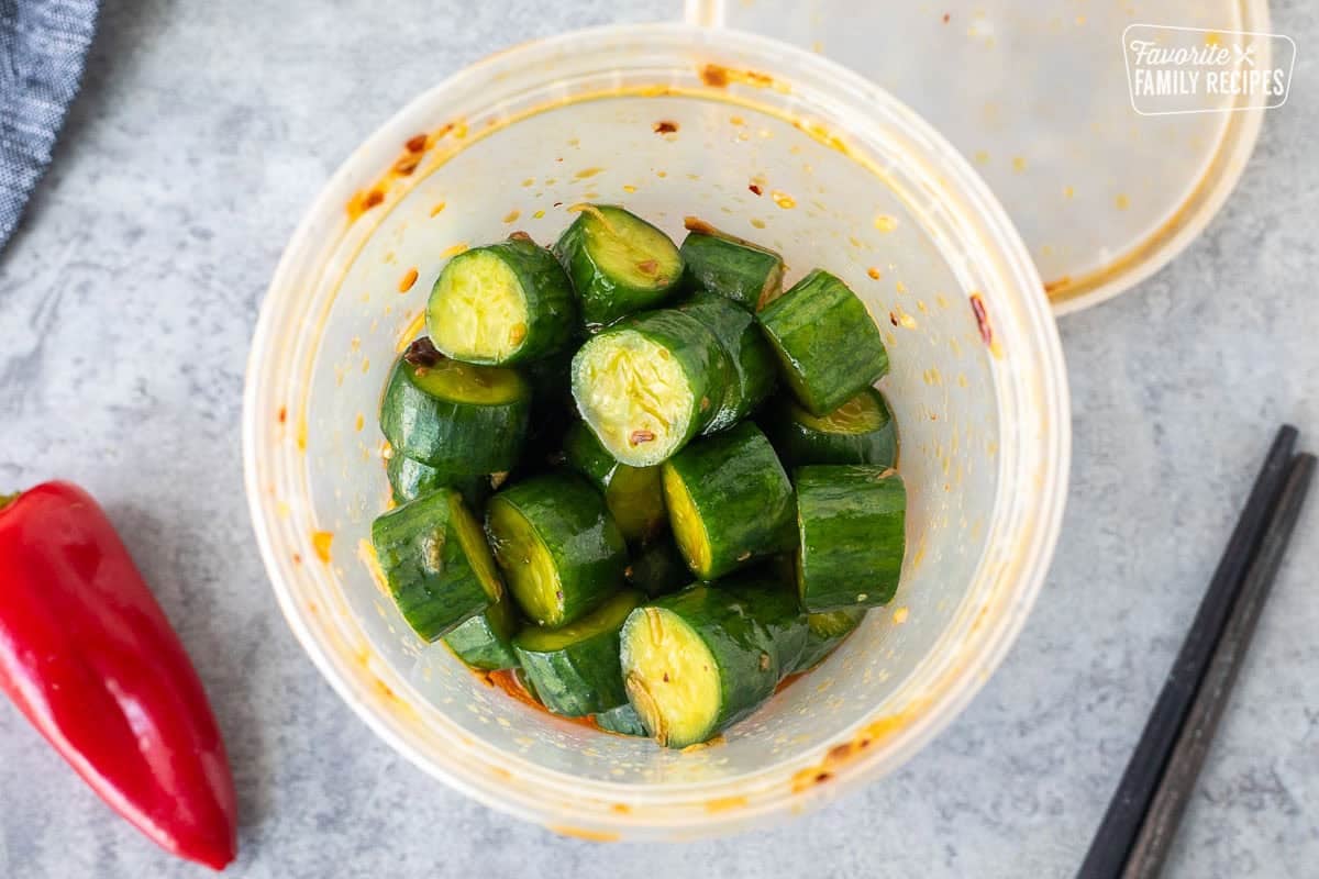 Plastic container with marinaded Din Tai Fung Cucumber Salad.