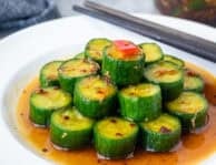 Assembled Din Tai Fung Cucumber Salad on a plate with chop sticks.
