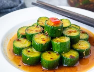 Assembled Din Tai Fung Cucumber Salad on a plate with chop sticks.