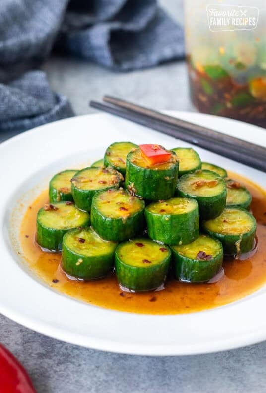 Assembled Din Tai Fung Cucumber Salad on a plate with chop sticks.