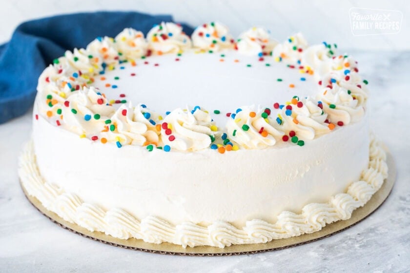 Decorated Ice Cream Cake with sprinkles on a stand.