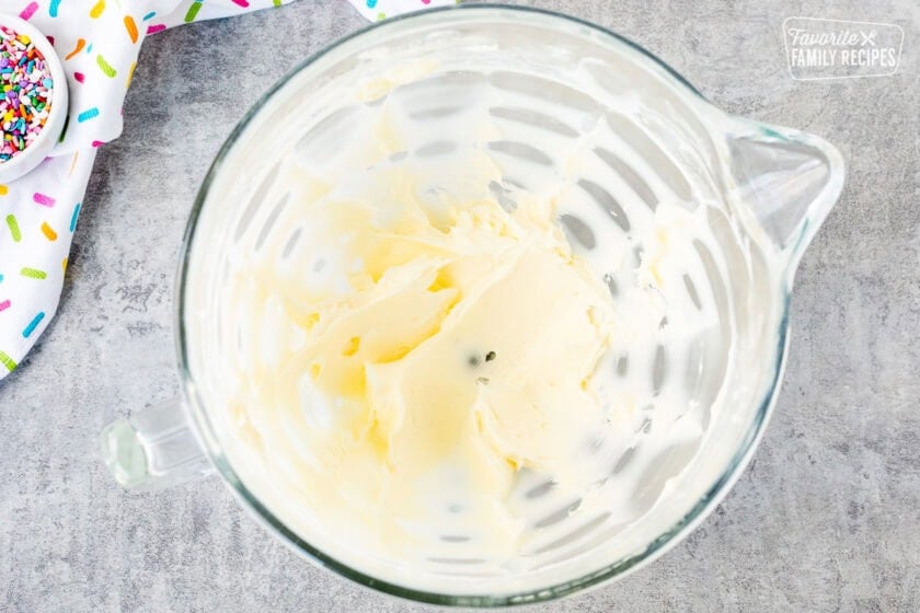 Glass mixing bowl with creamed butter.