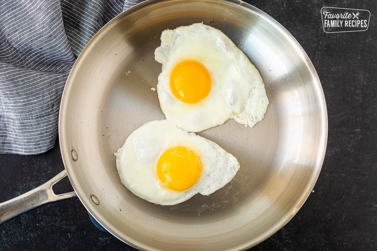Two eggs sunny side up in a skillet.