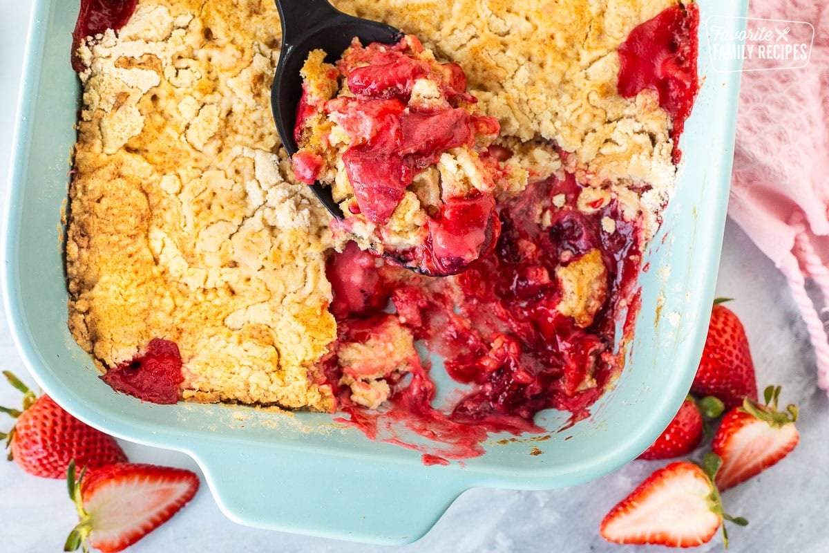 Strawberry Cheesecake Dump Cake scoop resting in dish.