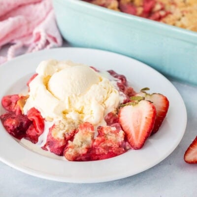 Strawberry Cheesecake Dump Cake topped with vanilla ice cream.