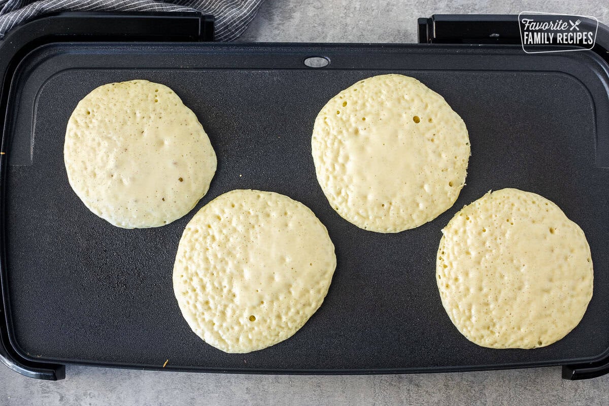 Bubbling pancakes from scratch on the griddle.