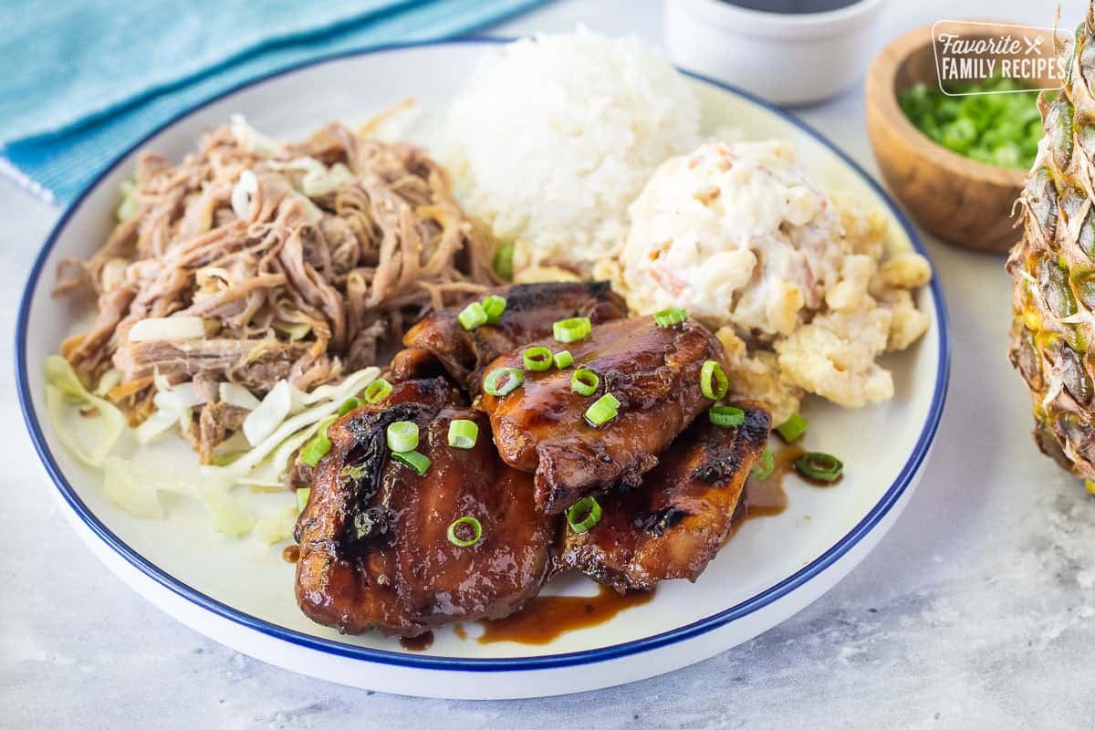 There are few things in this world better than a good Hawaiian plate lunch. Here you will find everything you need to make a Hawaiian plate lunch at home! Hawaiian Plate Lunch with teriyaki chicken, kalua pork, white rice and Mac salad.