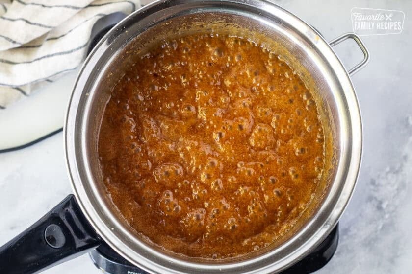 Boiling salted caramel sauce in a saucepan.