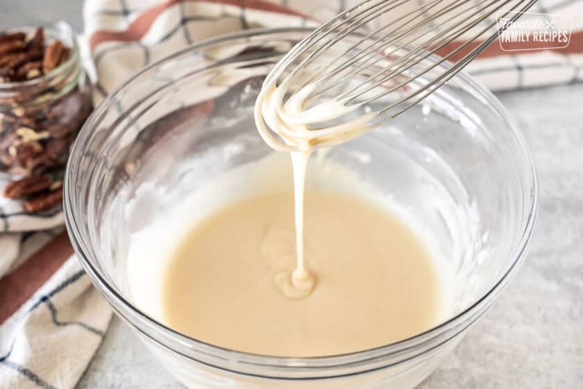 Whisk with drizzling maple glaze into bowl of maple glaze.