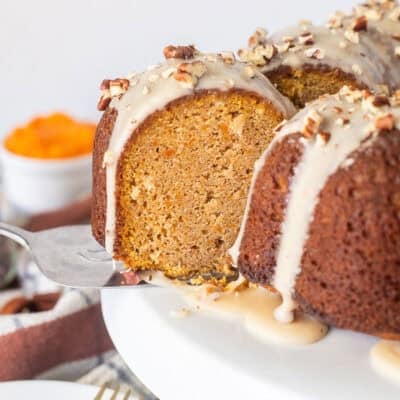 Slice of Sweet Potato Pound Cake with a maple glaze on a serving spatula coming out of the cake.
