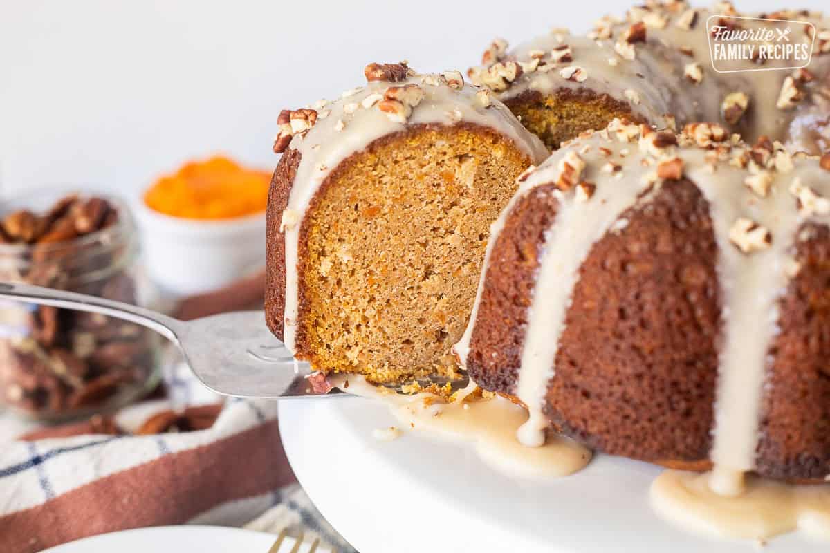 Slice of Sweet Potato Pound Cake with a maple glaze on a serving spatula coming out of the cake.