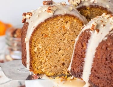 Slice of Sweet Potato Pound Cake with a maple glaze on a serving spatula coming out of the cake.