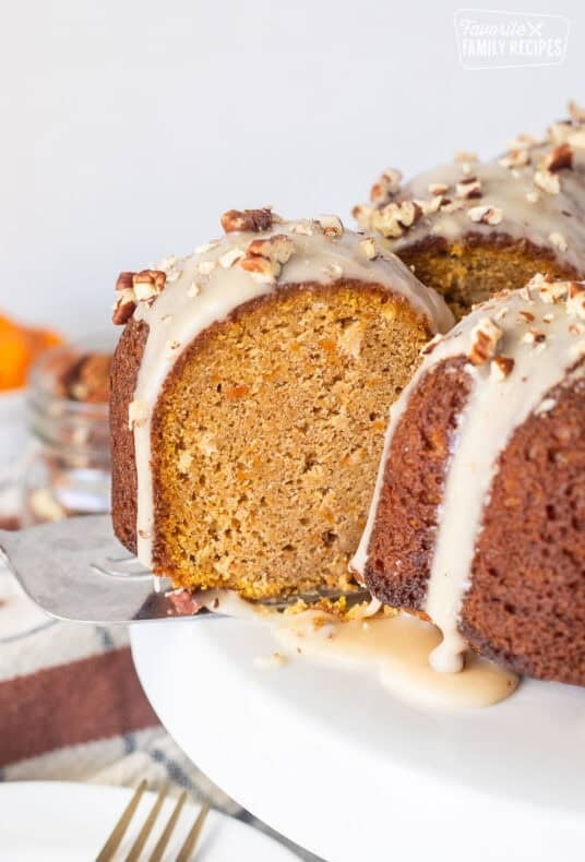 Slice of Sweet Potato Pound Cake with a maple glaze on a serving spatula coming out of the cake.