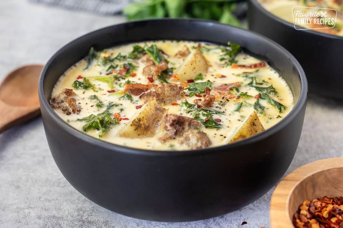 Bowl of Zuppa Toscana soup with sausage, kale, bacon, potatoes and a creamy chicken broth.