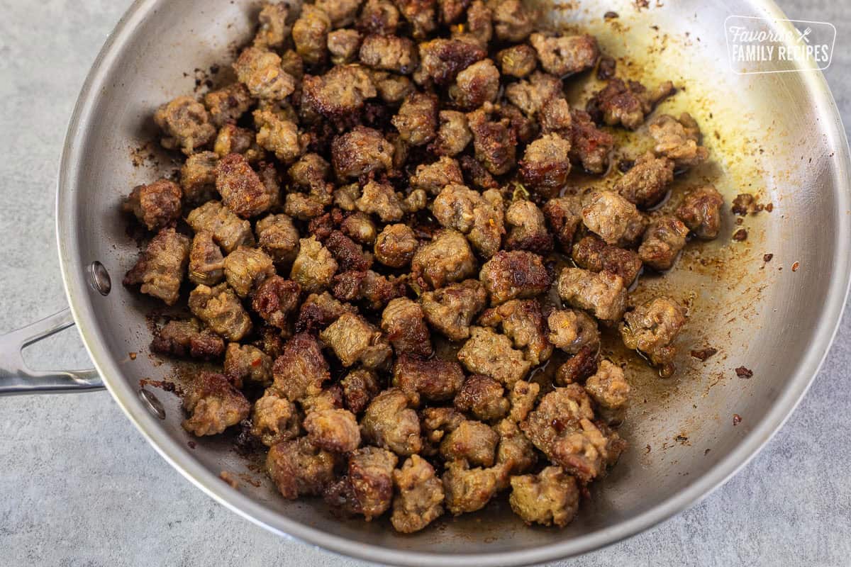 Cooked sausage pieces in a skillet.