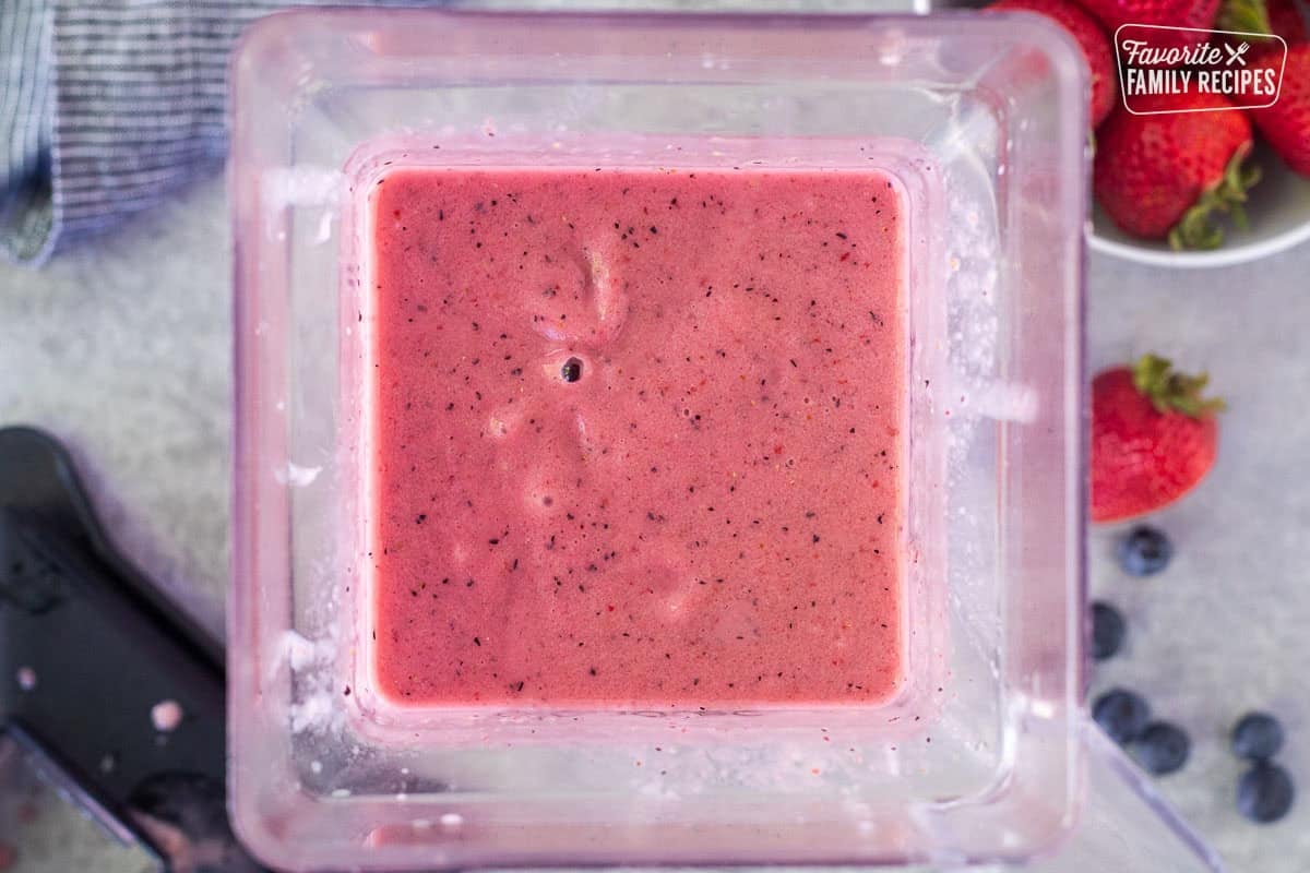Blender with blended berry banana smoothie.