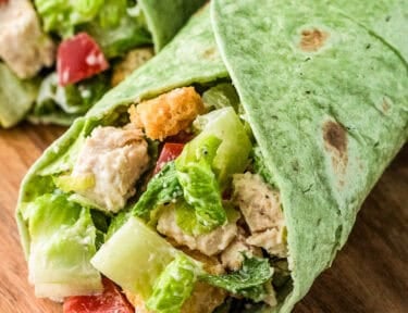 Chicken Caesar Wrap with romaine lettuce, chicken, croutons and tomatoes.