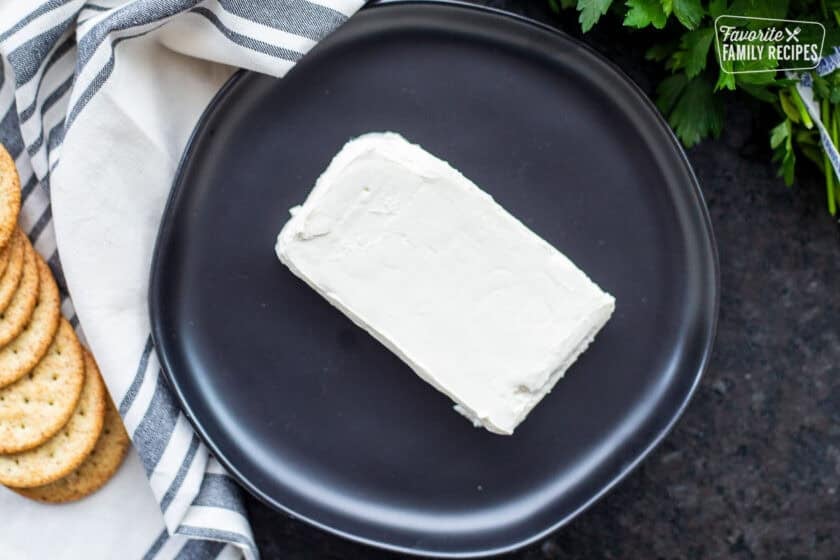 Plate with a brick of cream cheese.