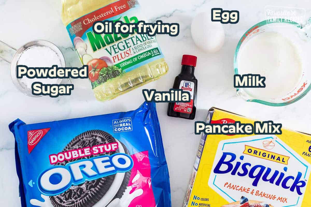 Ingredients to make Deep Fried Oreos including vegetable oil, milk, Bisquick, vanilla, egg, powdered sugar and Oreos.