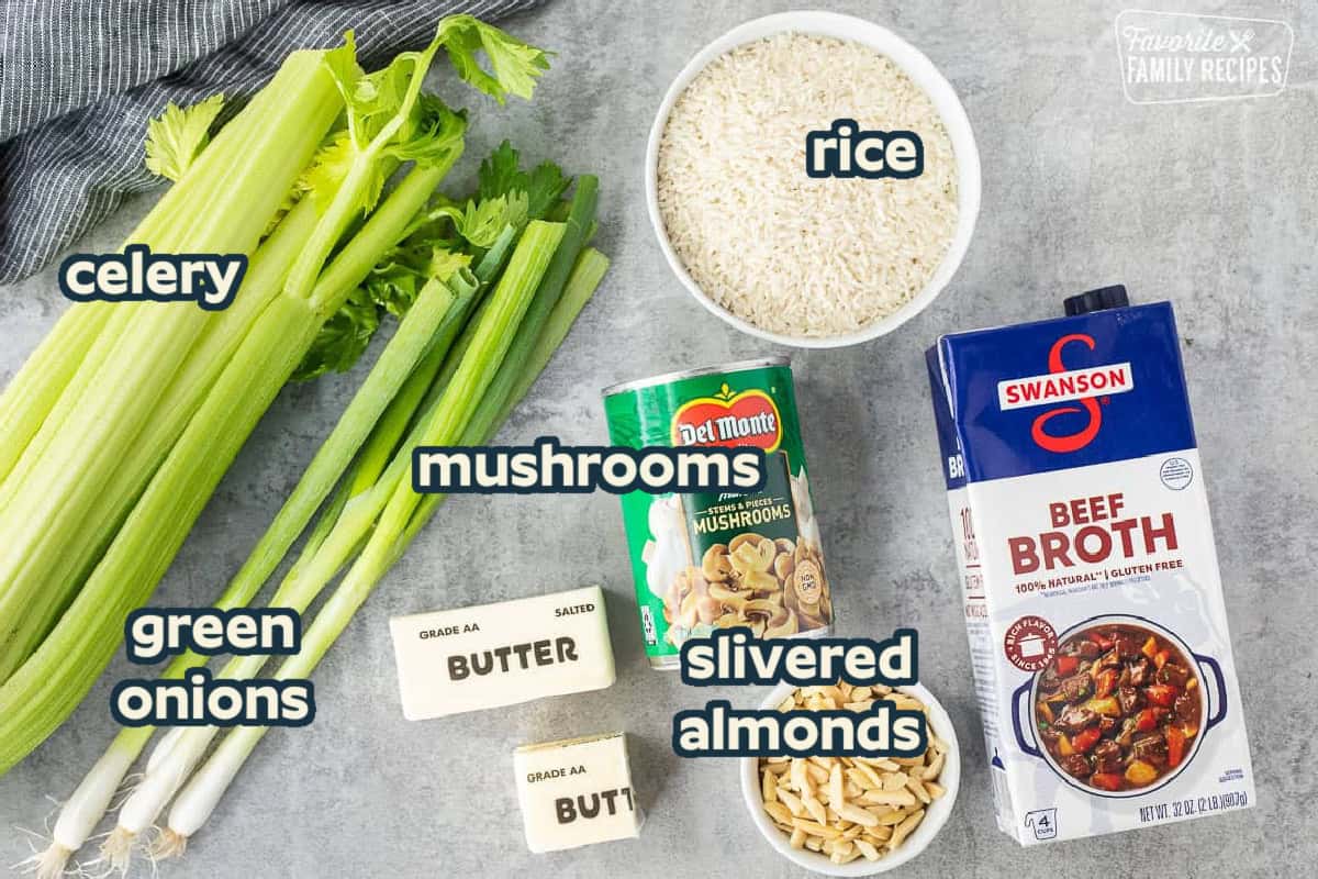 Ingredients to make Mushroom Rice including rice, mushrooms, beef broth, slivered almonds, butter, green onions and celery.