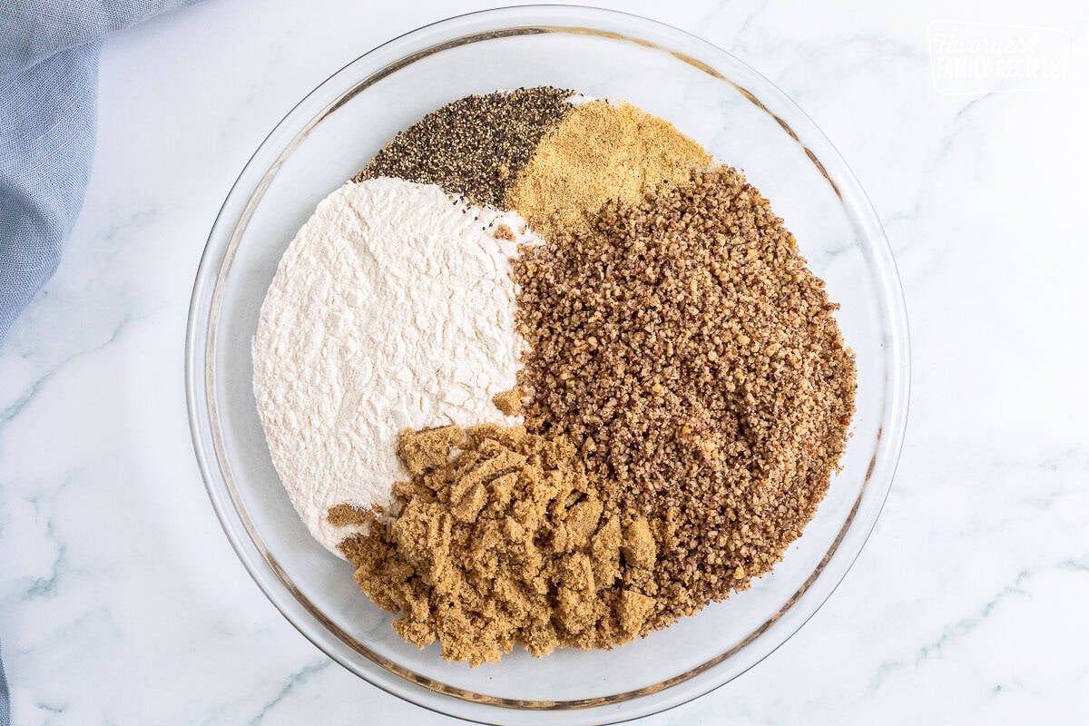 Glass bowl with crushed pecans, brown sugar, wondra and seasonings.
