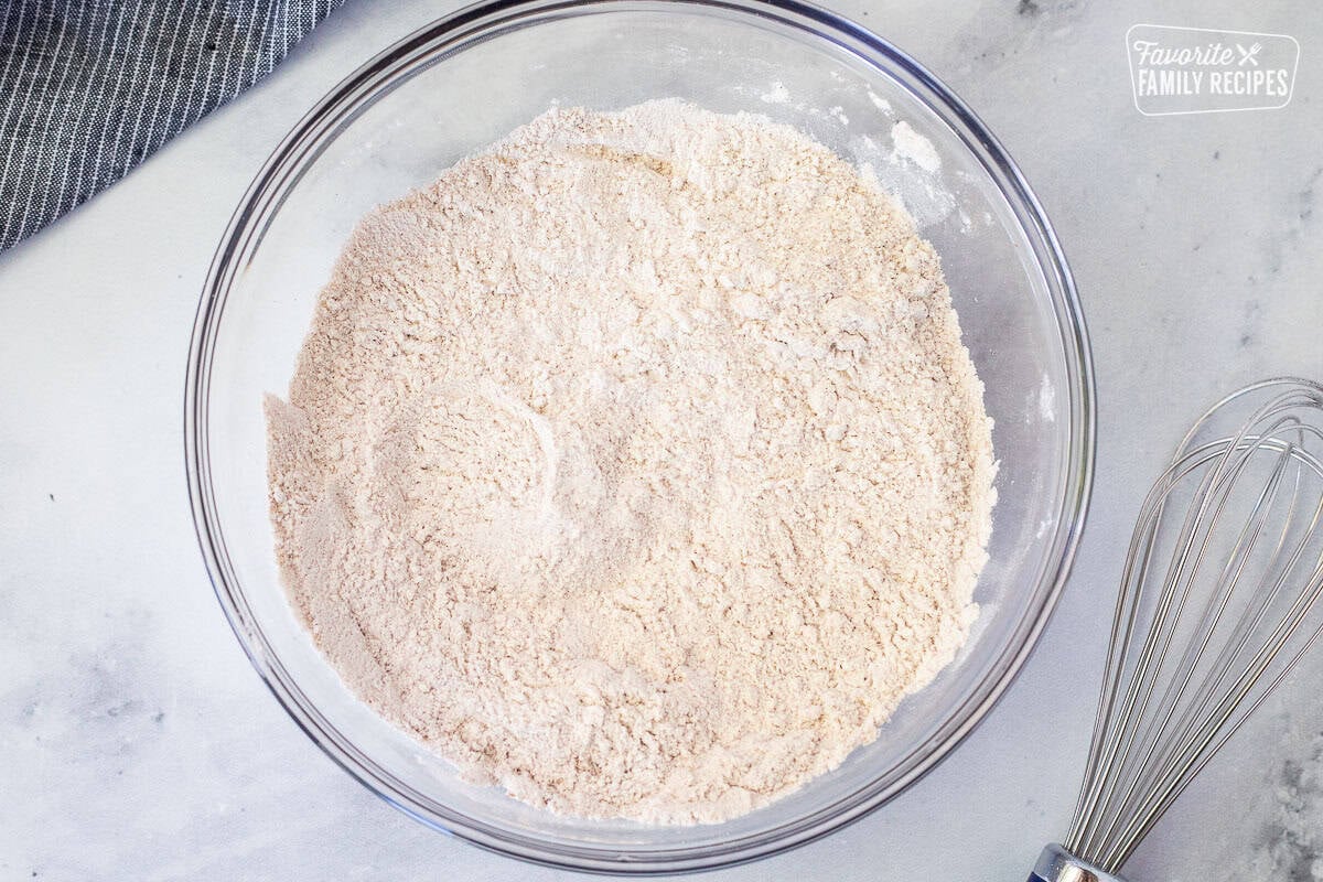 Glass bowl of dry ingredients to make pumpkin chocolate chip muffins.