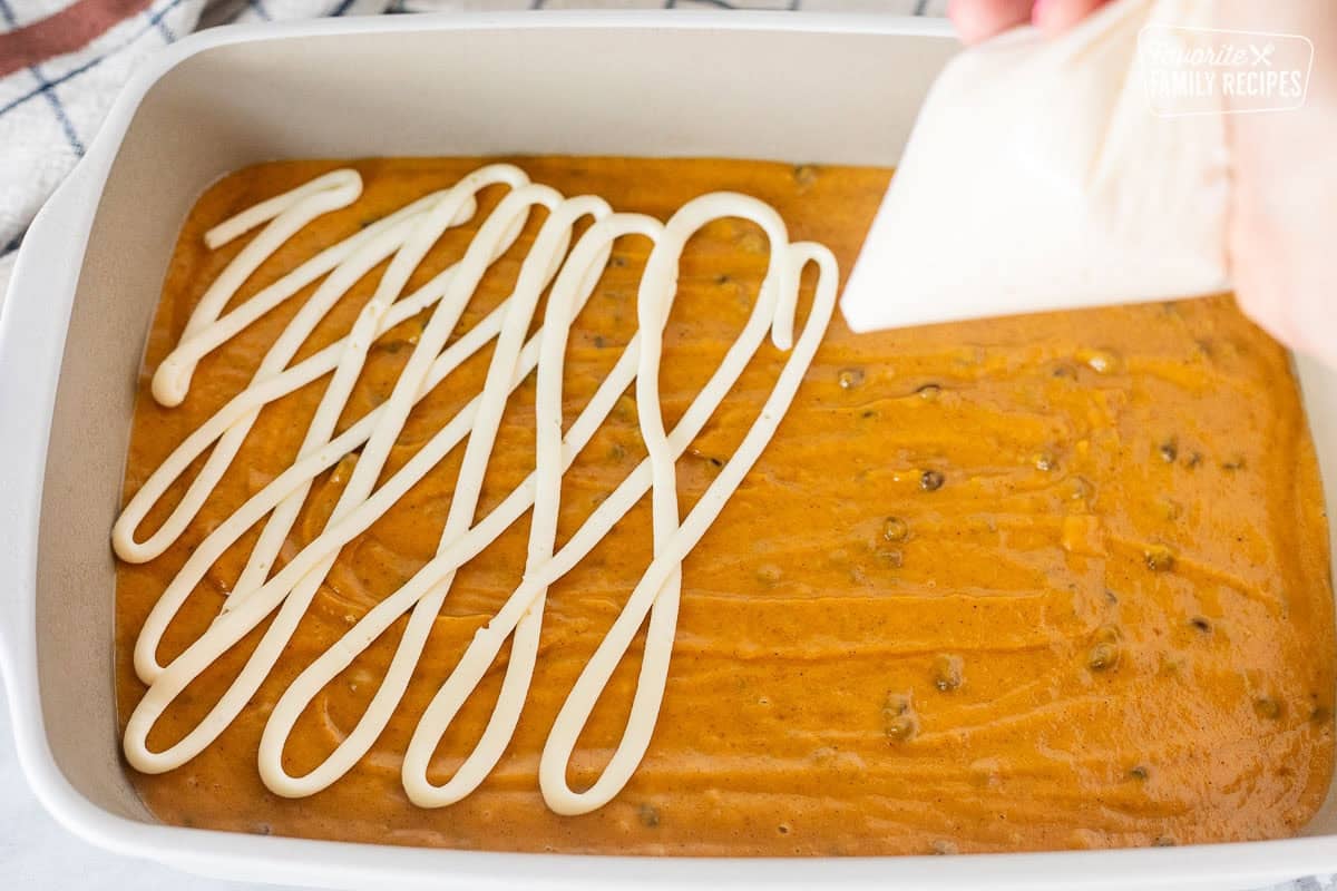 Cream cheese mixture piped on top of pumpkin coffee cake batter.