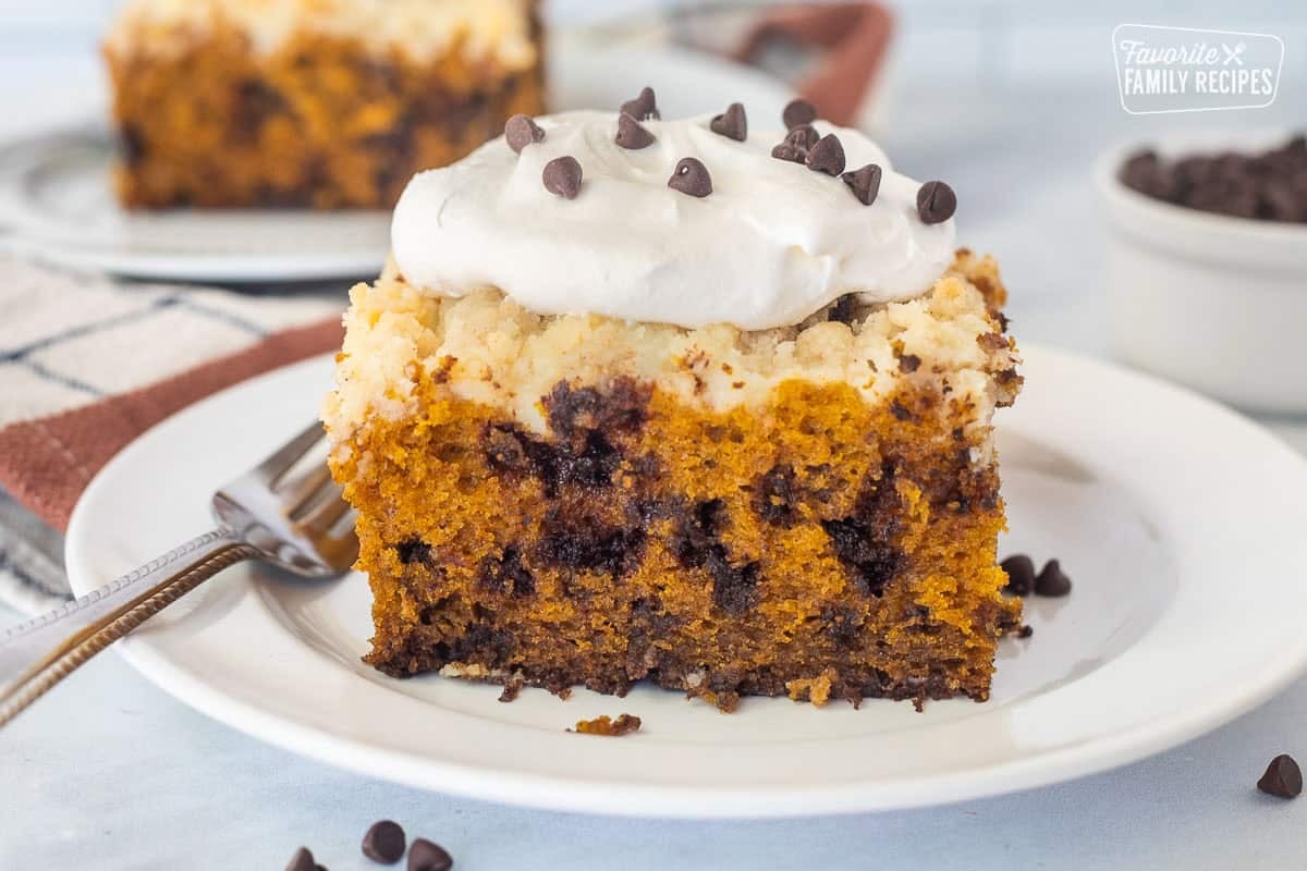 Slice of Pumpkin Coffee Cake with whipped cream and mini chocolate chips.