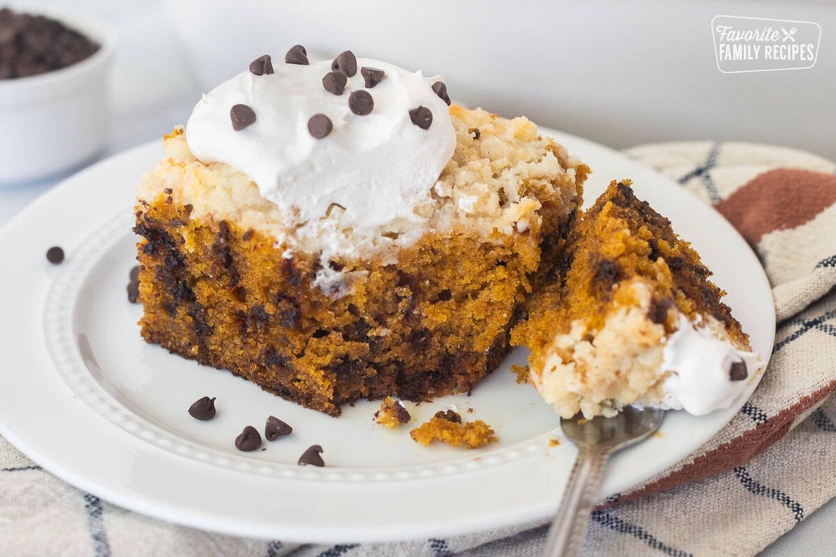 Corner cut with fork from slice of chocolate chip pumpkin coffee cake on a plate.