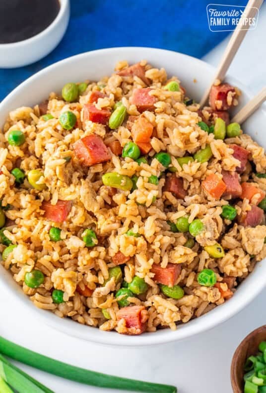 Bowl of spam fried rice with spam, carrots, peas, soy beans and scrambled eggs.